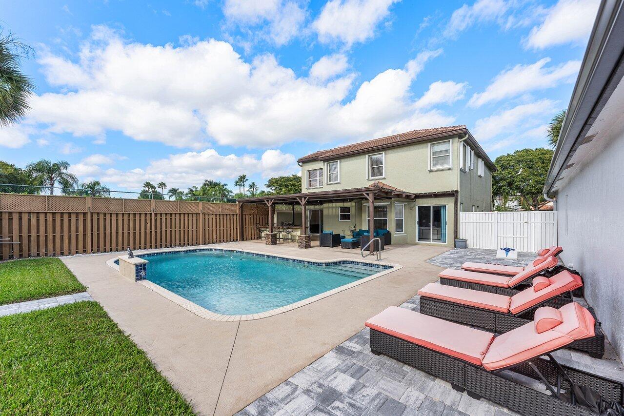 9434 Fox Trot Lane Boca Raton, FL 33496 - Photo 34 of 66 a view of a house with swimming pool and sitting area