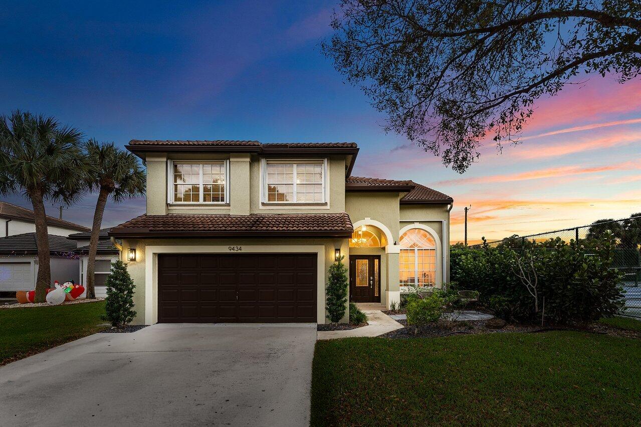 9434 Fox Trot Lane Boca Raton, FL 33496 - Photo 45 of 66 a front view of a house with yard and green space