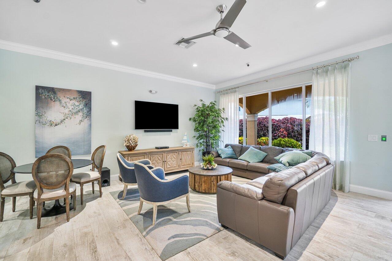 9434 Fox Trot Lane Boca Raton, FL 33496 - Photo 60 of 66 a living room with furniture and a flat screen tv