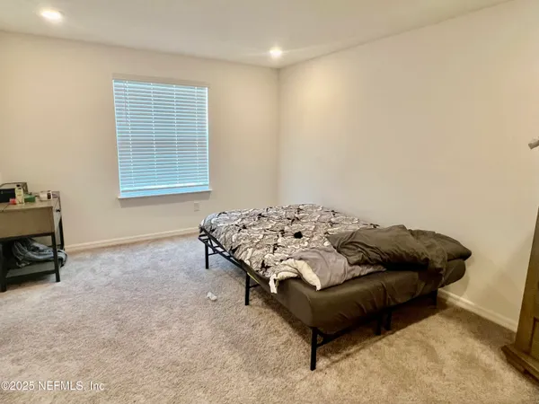 a bedroom with furniture and a bed