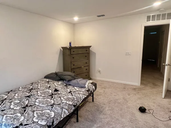 a bedroom with a bed and walk in closet