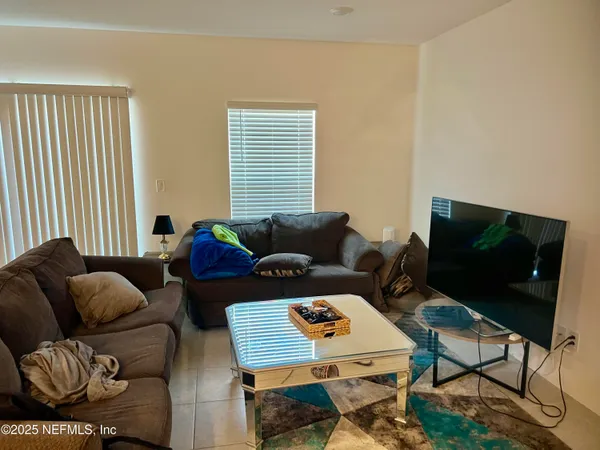 a living room with furniture and a flat screen tv