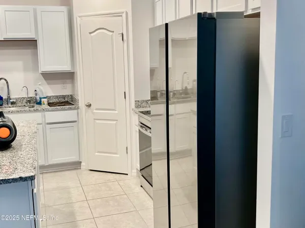a kitchen with stainless steel appliances granite countertop a refrigerator and a stove