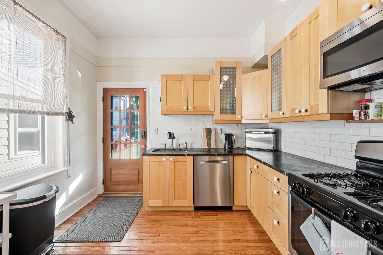 346 East Union Street Burlington, NJ 08016 - Photo 16 of 48 a kitchen with stainless steel appliances granite countertop a stove a sink and a microwave