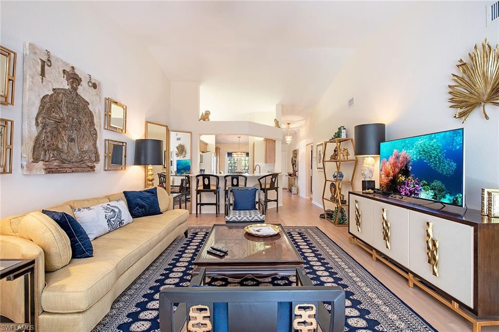 841 Tanbark Drive, Unit 202 Naples, FL 34108 - Photo 1 of 12 a living room with furniture and a flat screen tv