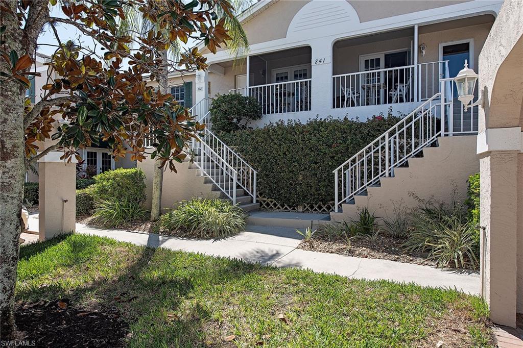 841 Tanbark Drive, Unit 202 Naples, FL 34108 - Photo 11 of 12 a front view of house and yard with green space