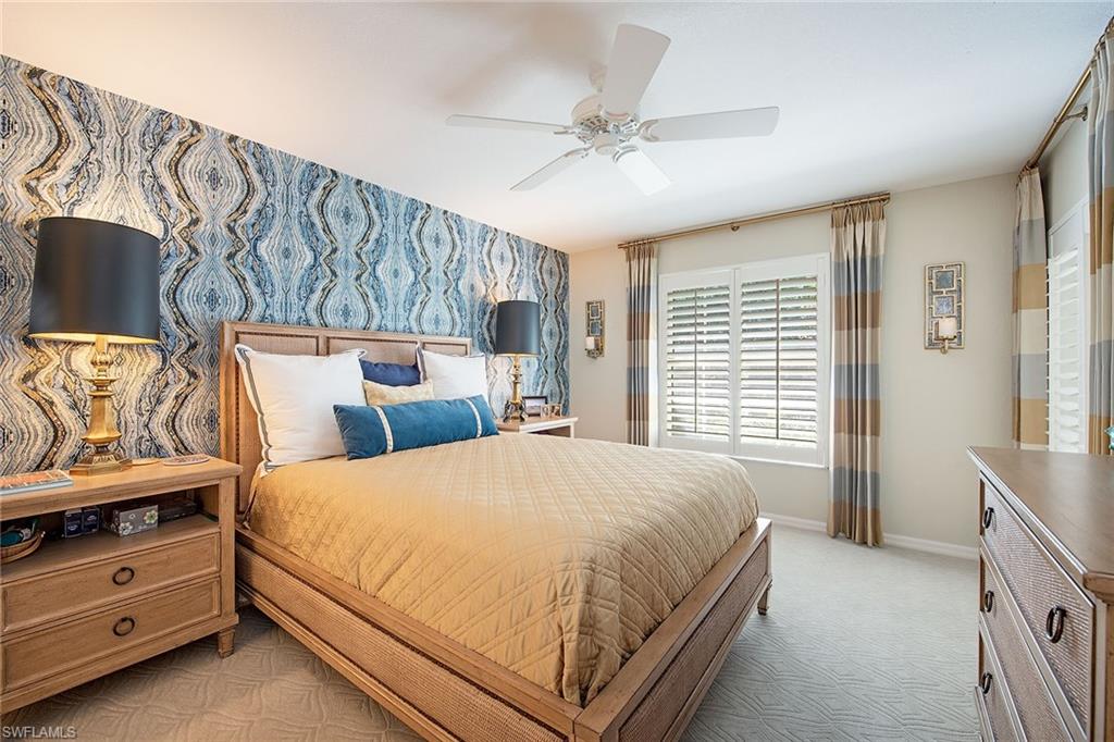 841 Tanbark Drive, Unit 202 Naples, FL 34108 - Photo 5 of 12 a bedroom with a bed and a window