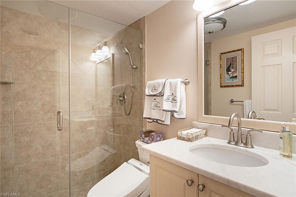 841 Tanbark Drive, Unit 202 Naples, FL 34108 - Photo 8 of 12 a bathroom with a sink toilet and shower