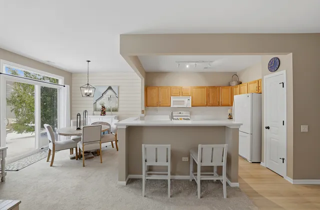 a dining room with a table chairs and a open kitchen view