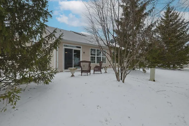 a view of a house with backyard porch and sitting area