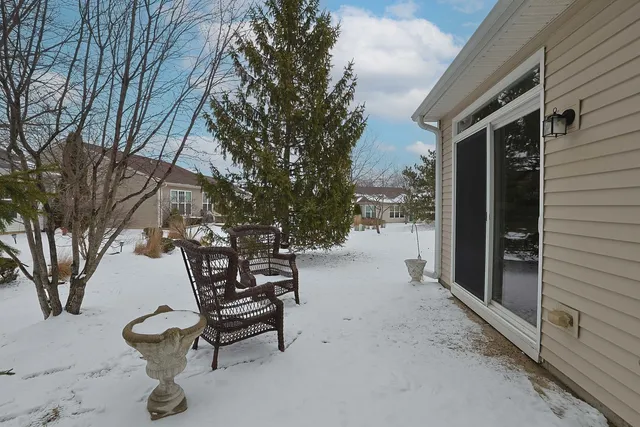 a backyard of a house with table and chairs
