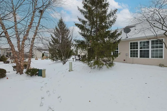 a view of a house with snow on the road