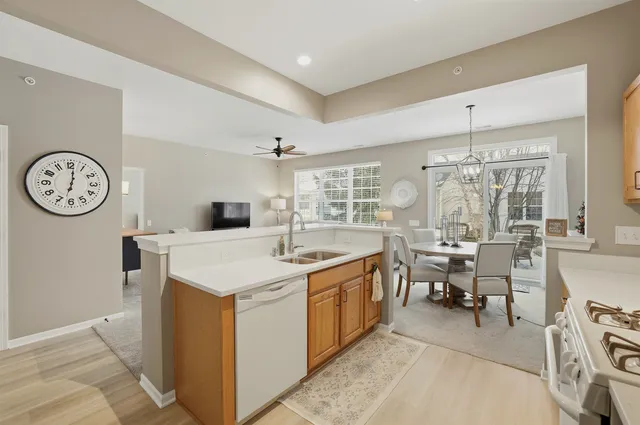 a kitchen with a stove a clock and a clock on the wall