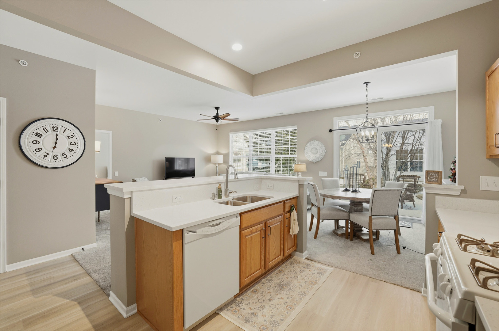 13306 Arboretum Lane Huntley, IL 60142 - Photo 7 of 19 a kitchen with a stove a clock and a clock on the wall
