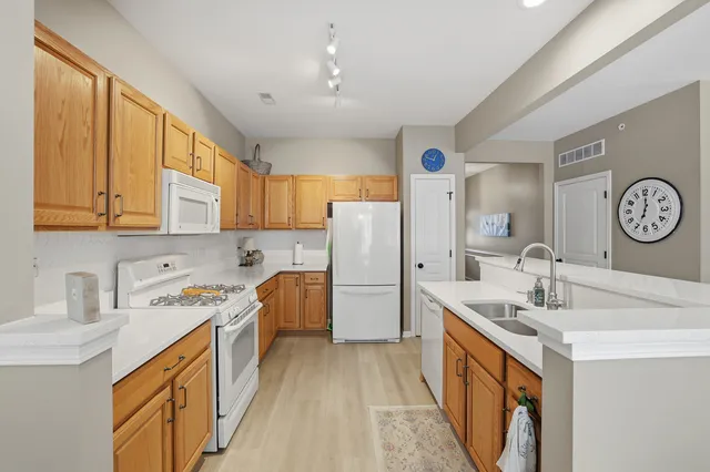 a kitchen with a sink stove and refrigerator