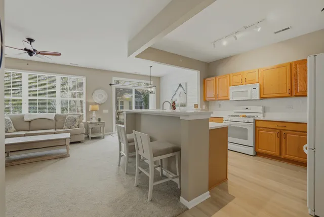 a kitchen with stainless steel appliances kitchen island granite countertop a sink and cabinets