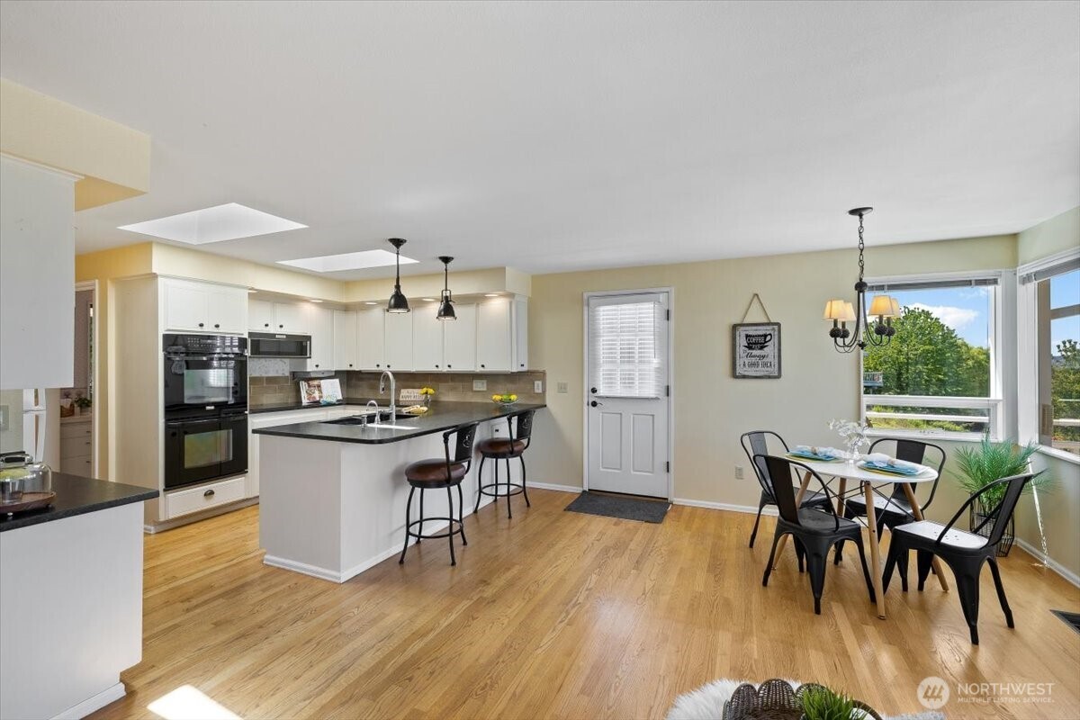 2606 49th Place Southwest Everett, WA 98203 - Photo 8 of 37 a kitchen with a table and chairs in it