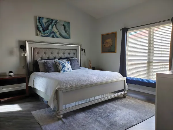 a bed sitting in a bedroom next to a window