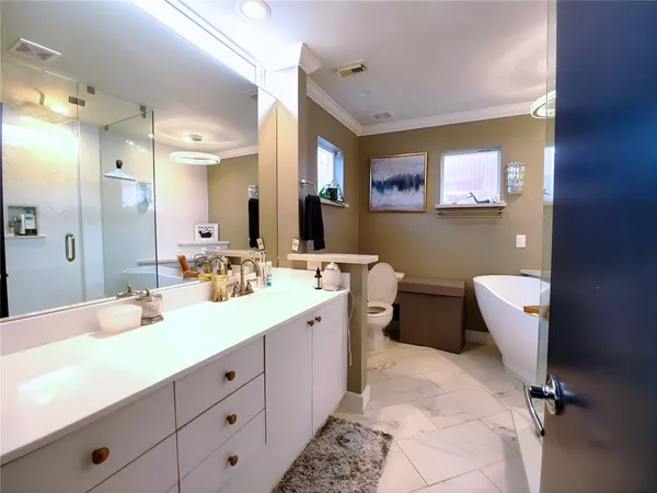 a bathroom with a double vanity sink mirror and toilet
