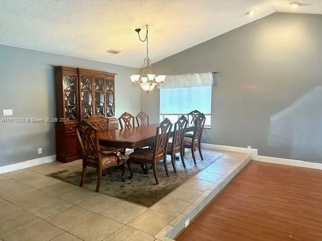 a view of a dining room with furniture window and chandelier