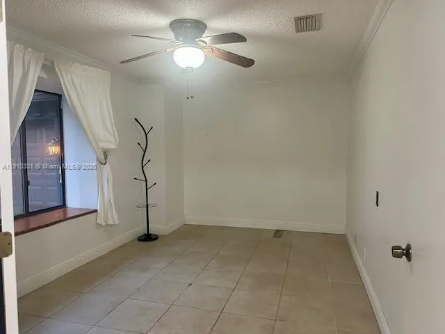 an empty room with a empty space and a ceiling fan