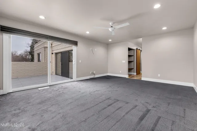 a view of empty room with wooden walls