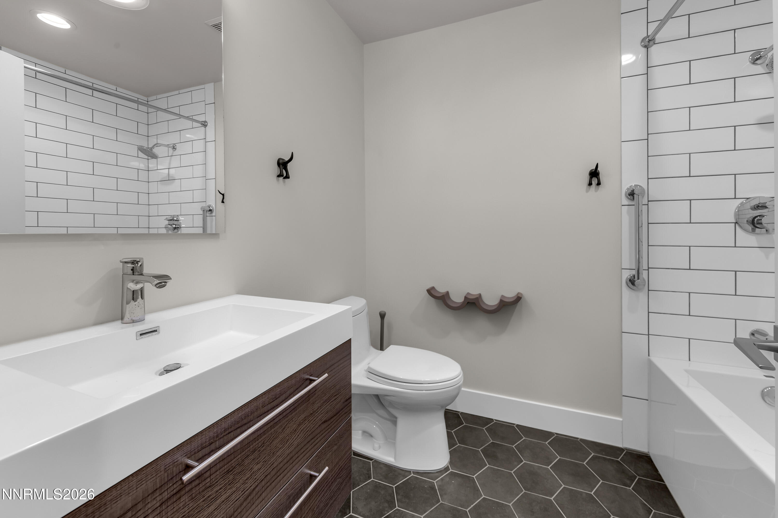 4957 Lakeridge Terrace West Reno, NV 89509 - Photo 27 of 44 a bathroom with a sink a toilet and shower