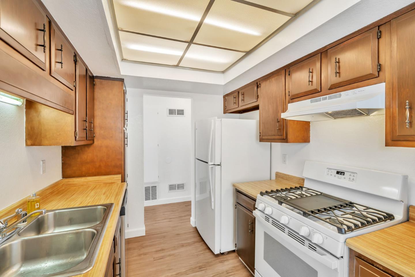 2416 North Main Street, Unit F Salinas, CA 93906 - Photo 11 of 39 a kitchen with stainless steel appliances granite countertop a stove and a refrigerator