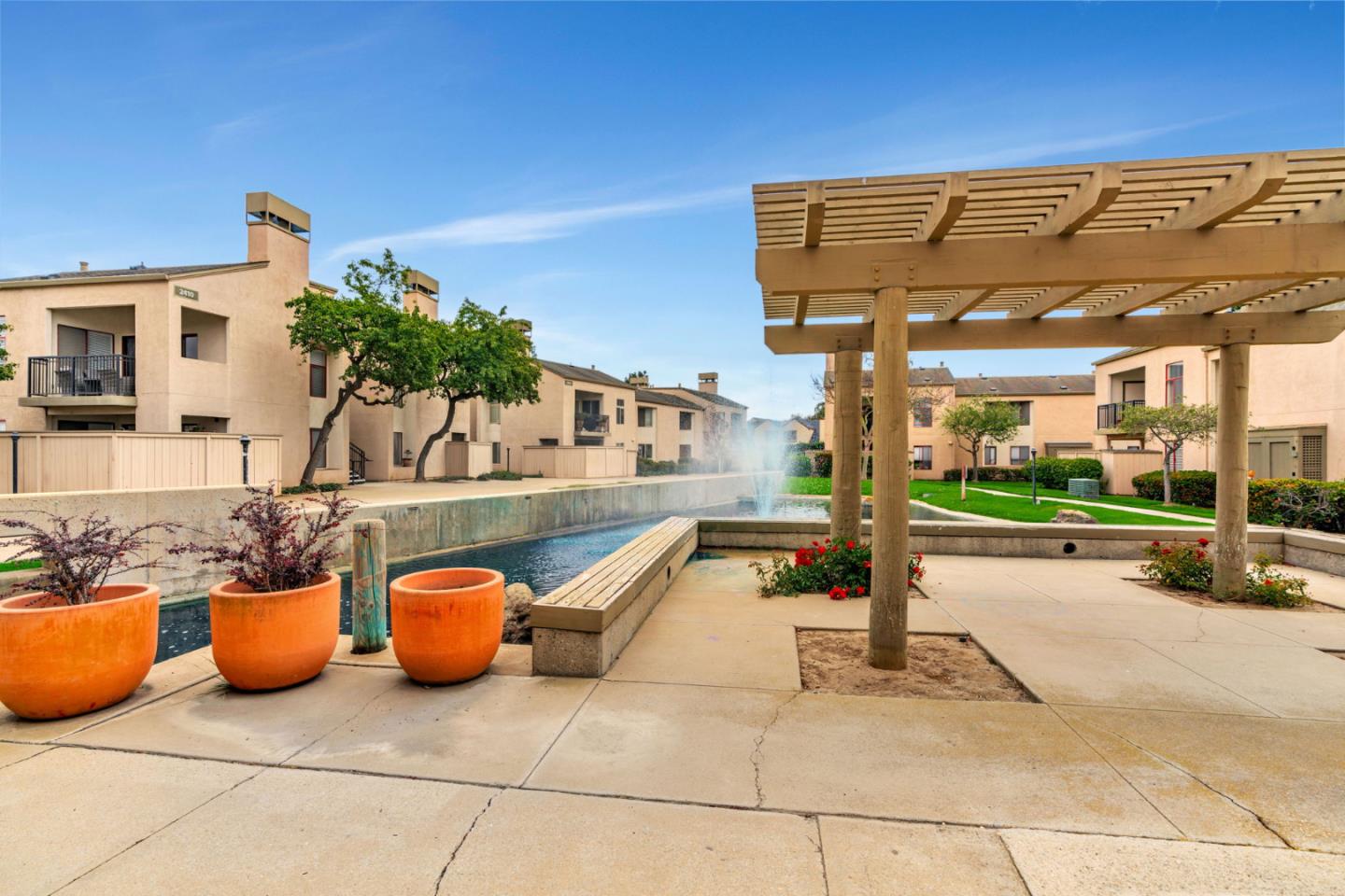 2416 North Main Street, Unit F Salinas, CA 93906 - Photo 34 of 39 a view of a patio with table and chairs potted plants with wooden fence