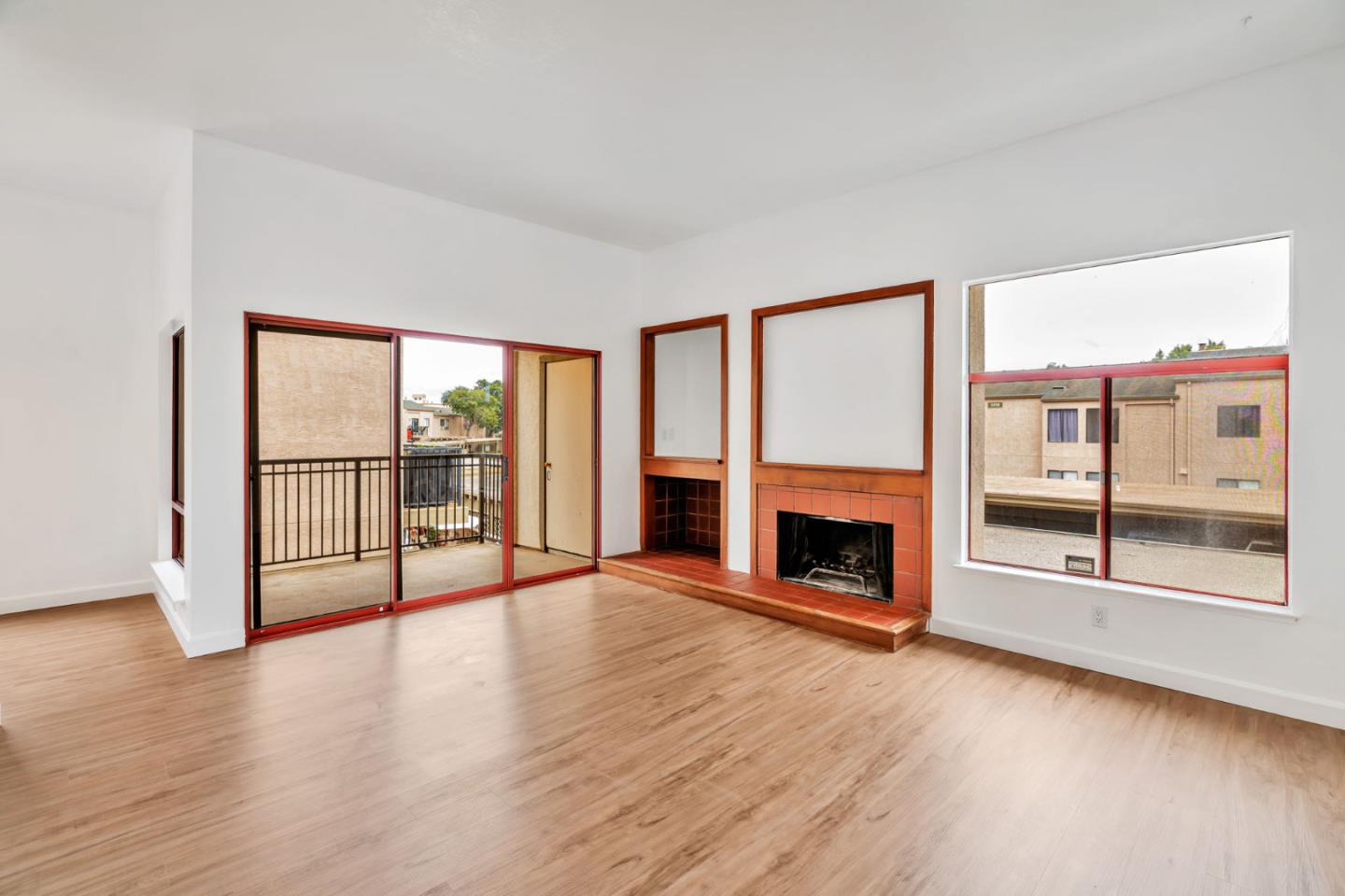 2416 North Main Street, Unit F Salinas, CA 93906 - Photo 4 of 39 wooden floor fireplace and windows in an empty room