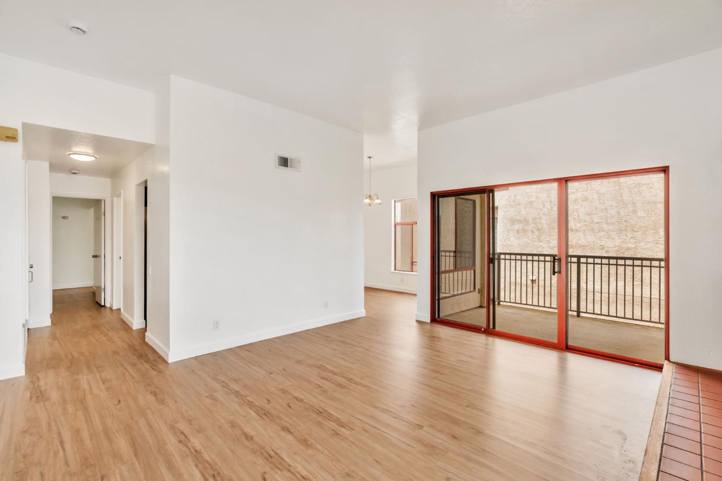 2416 North Main Street, Unit F Salinas, CA 93906 - Photo 5 of 39 a view of an empty room with wooden floor and a window