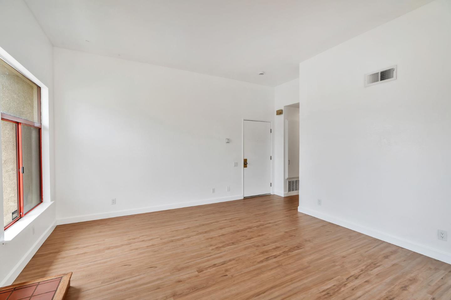 2416 North Main Street, Unit F Salinas, CA 93906 - Photo 7 of 39 a view of an empty room with wooden floor and a window