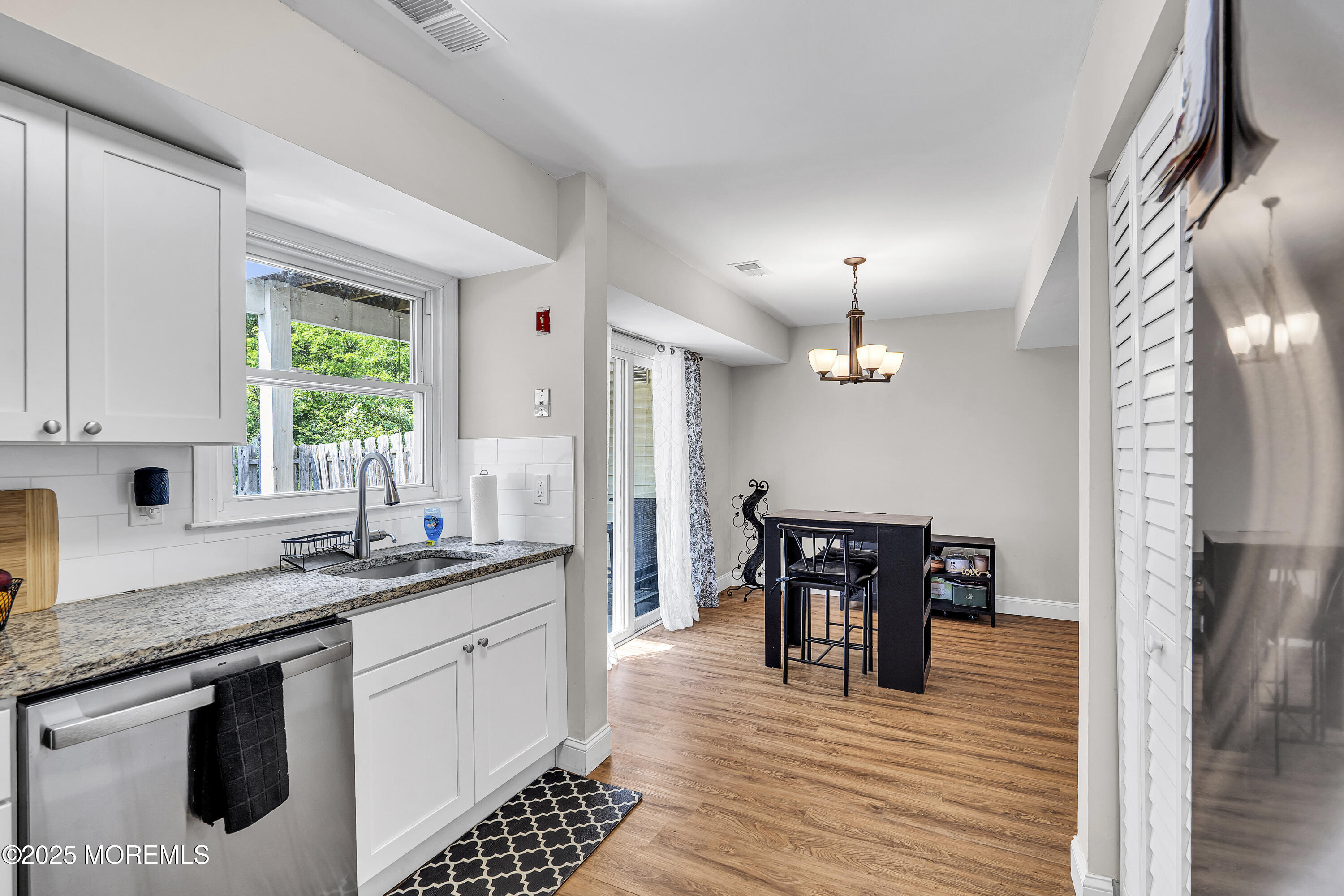 39 Colonial Court Jackson, NJ 08527 - Photo 20 of 26 a kitchen with stainless steel appliances granite countertop a sink a stove a refrigerator and wooden floor