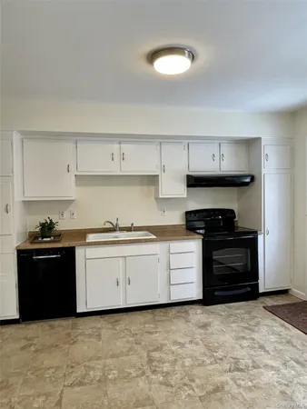 a kitchen with granite countertop a stove and a sink