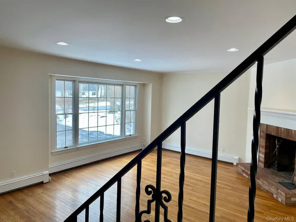 a view of an entryway with wooden floor and door