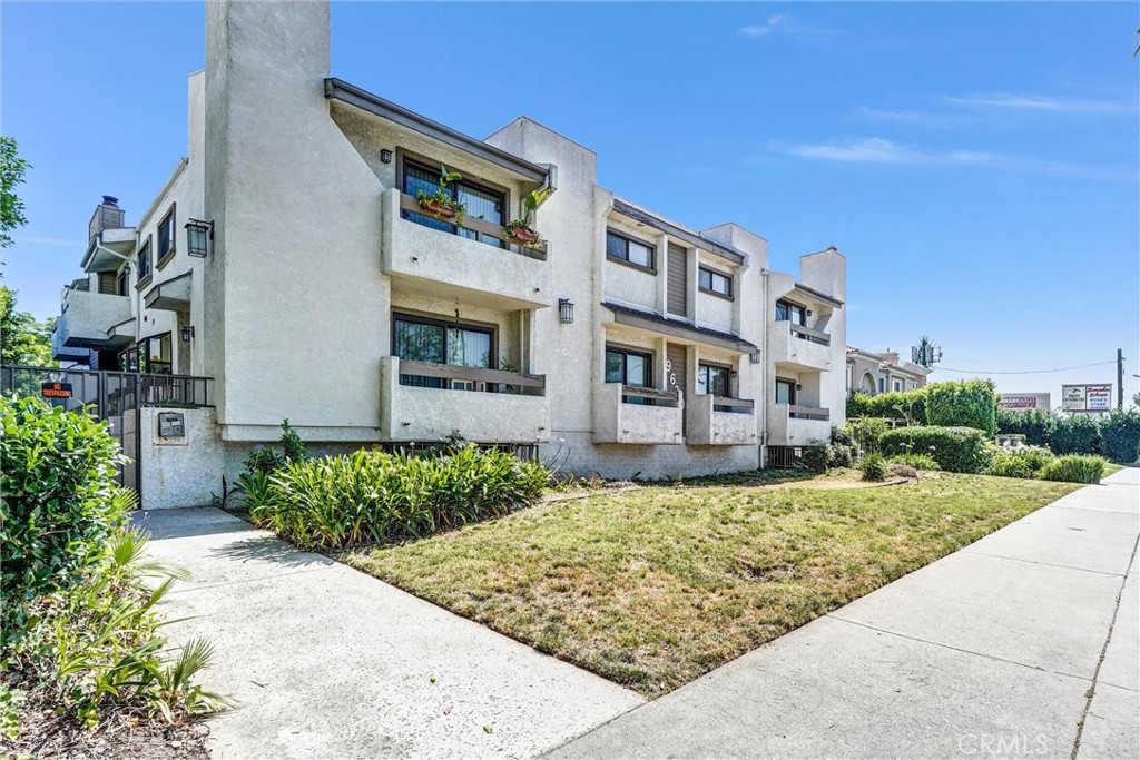 19620 Sherman Way, Unit 1 Reseda, CA 91335 - Photo 1 of 29 a view of a building with a yard