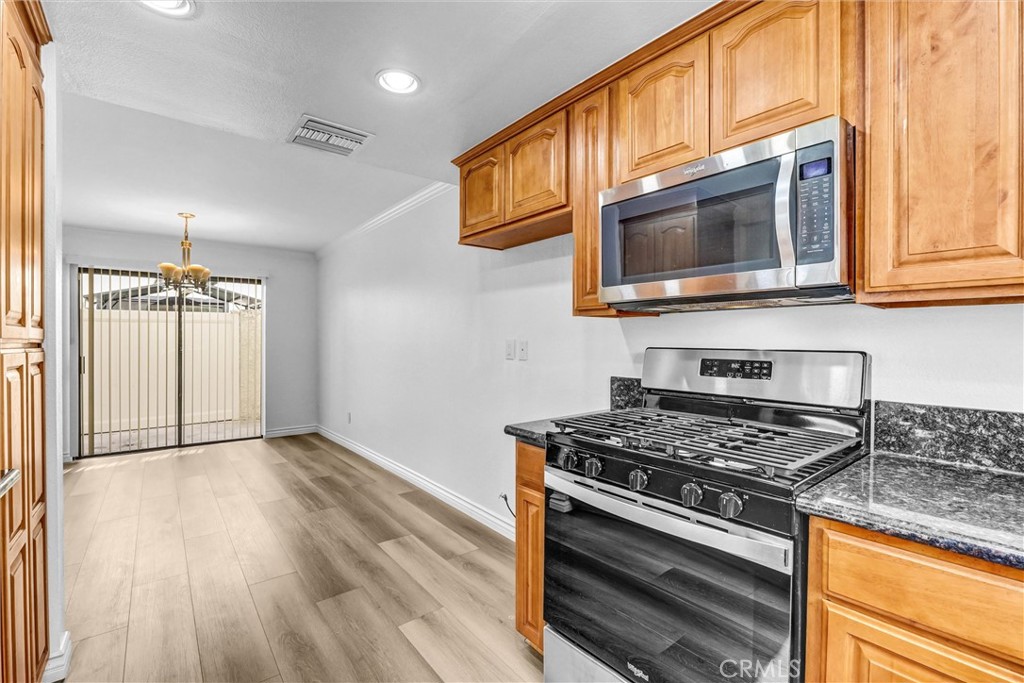 19620 Sherman Way, Unit 1 Reseda, CA 91335 - Photo 13 of 29 a kitchen with stainless steel appliances granite countertop a stove and a microwave