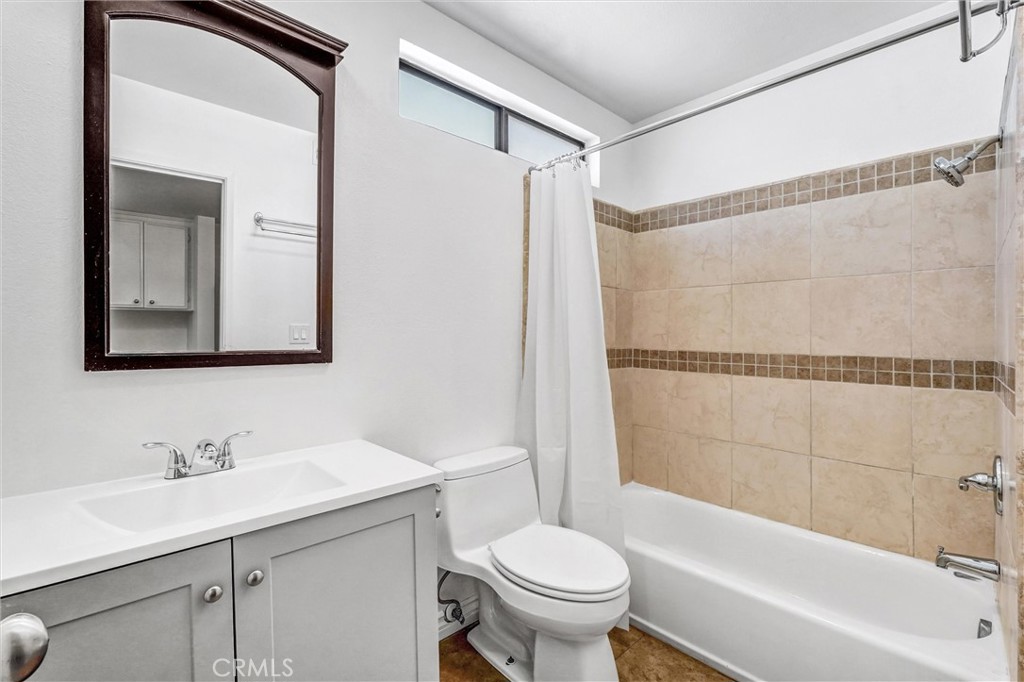 19620 Sherman Way, Unit 1 Reseda, CA 91335 - Photo 22 of 29 a bathroom with a sink toilet and shower