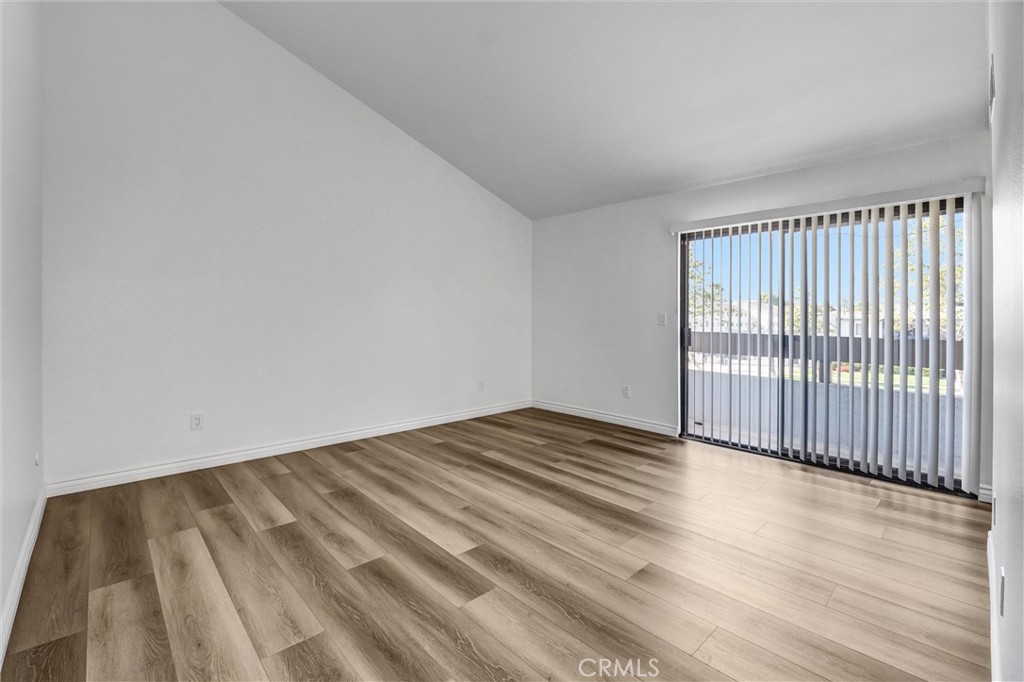 19620 Sherman Way, Unit 1 Reseda, CA 91335 - Photo 23 of 29 a view of an empty room with wooden floor
