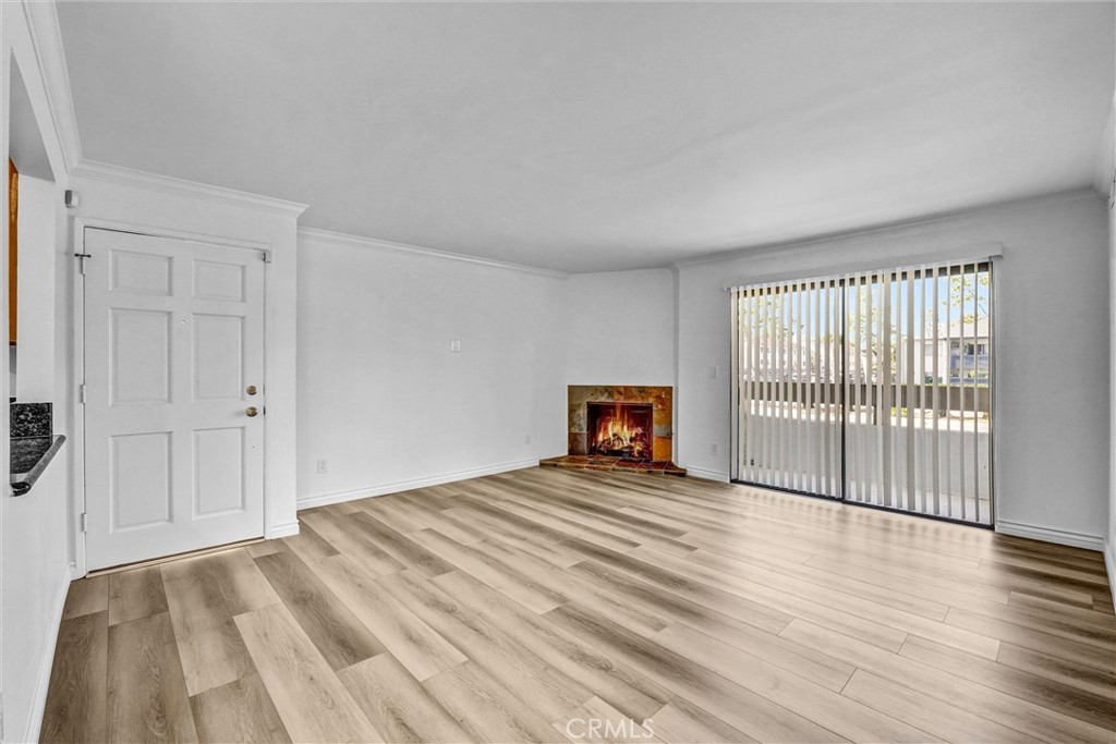 19620 Sherman Way, Unit 1 Reseda, CA 91335 - Photo 6 of 29 a view of a livingroom with wooden floor and a fireplace