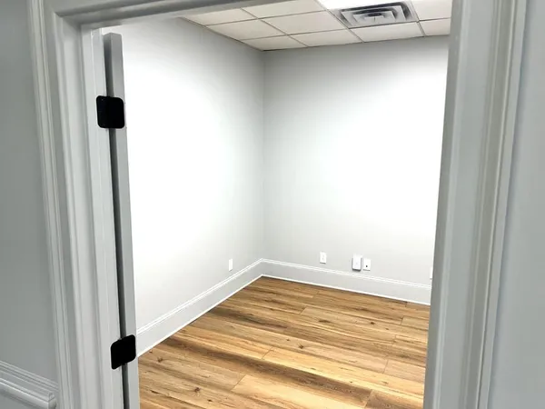 an empty room with wooden floor and closet