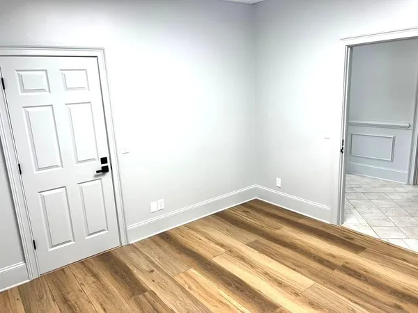 a view of a room with wooden floor