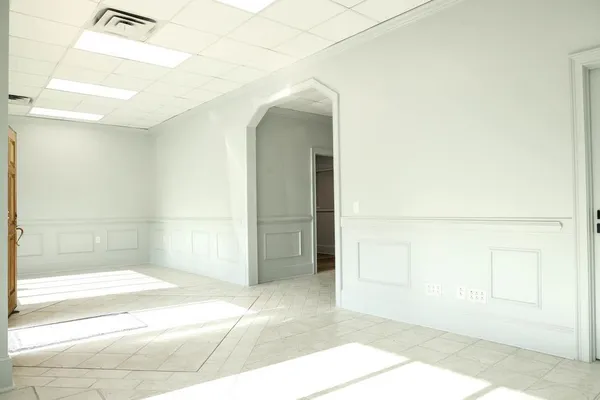 a view of a hallway with entryway and chandelier
