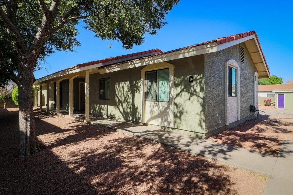 1336 East Mountain View Road, Unit 105 Phoenix, AZ 85020 - Photo 1 of 15 a front view of a house with garden