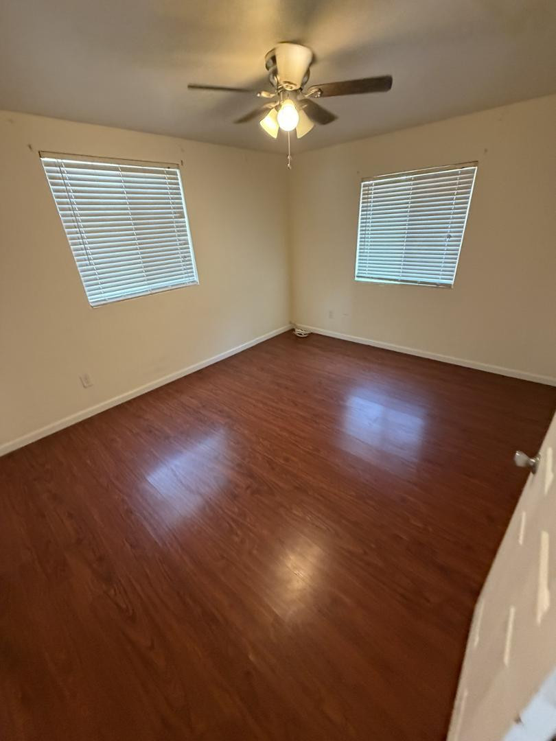 1336 East Mountain View Road, Unit 105 Phoenix, AZ 85020 - Photo 7 of 15 a view of an empty room with a window and wooden floor