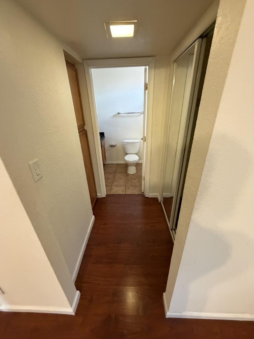 1336 East Mountain View Road, Unit 105 Phoenix, AZ 85020 - Photo 8 of 15 a view of a hallway with wooden floor and a living room