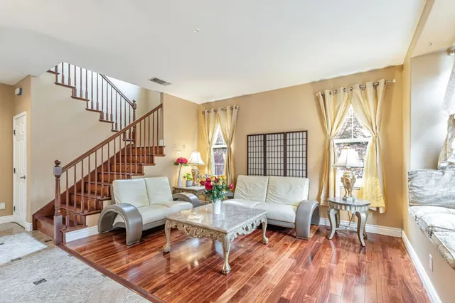 a living room with furniture a window and a flat screen tv