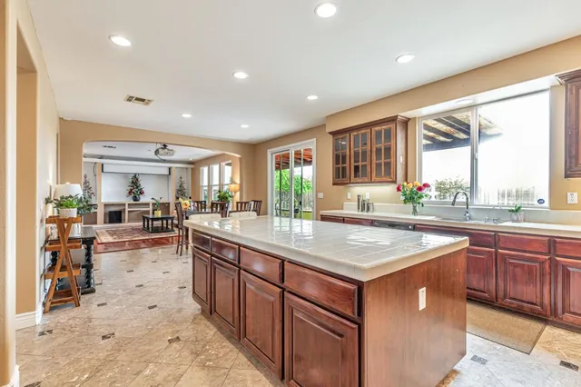 a dining room with furniture potted plants and wooden floor