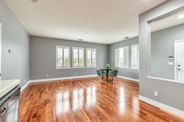 a hallway with wooden floor and closet
