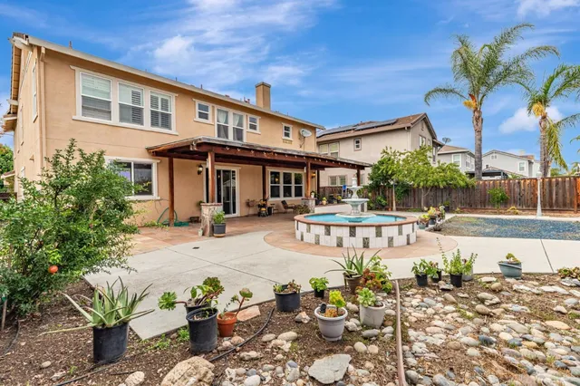 a view of a patio with table and chairs potted plants with wooden floor
